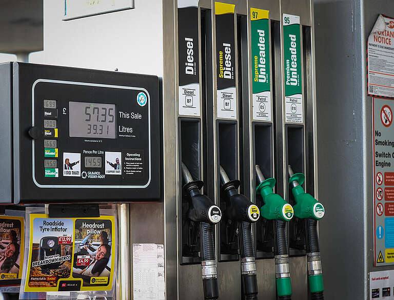 A petrol pump at a UK fuel station, with diesel and unleaded nozzles and a price display in pounds