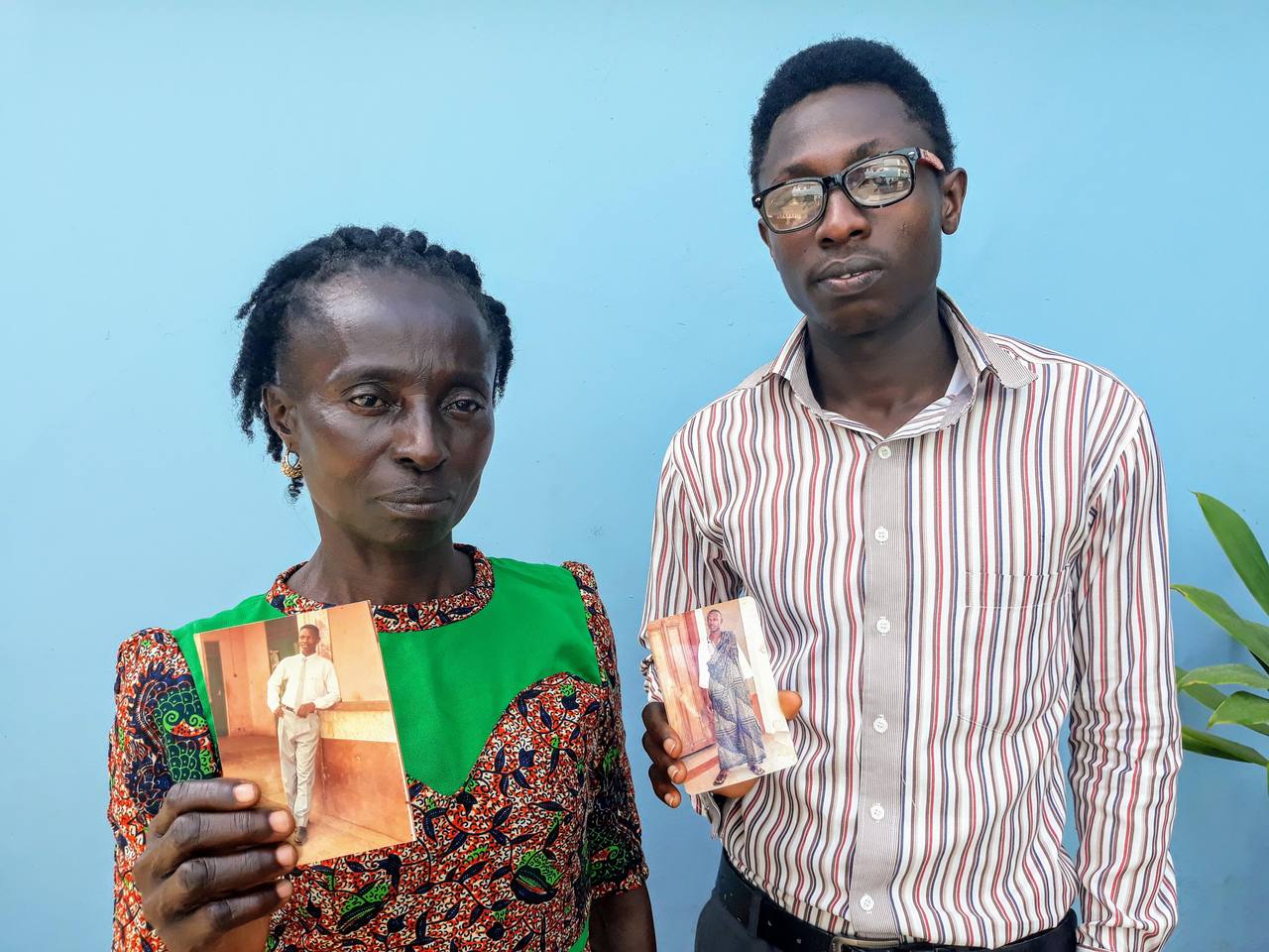 Family members of victims of Yahya Jammeh's rule in The Gambia holding photographs of their disappeared relatives