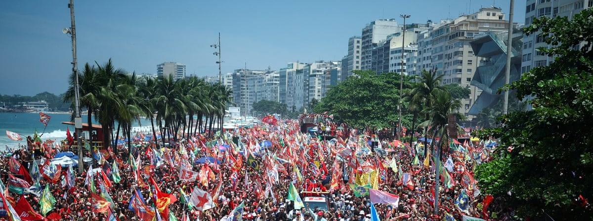 Thousands of Lula supporters carrying flags fill Copacabana beach in Rio de Janeiro on Saturday