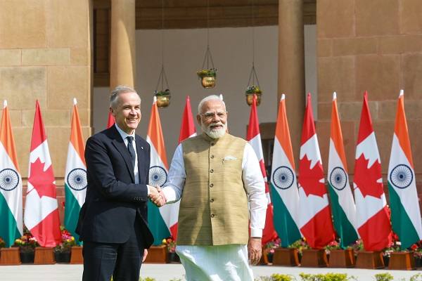Prime Minister Narendra Modi shaking hands with Canadian Prime Minister Mark Carney in front of Indian and Canadian flags (file photo)