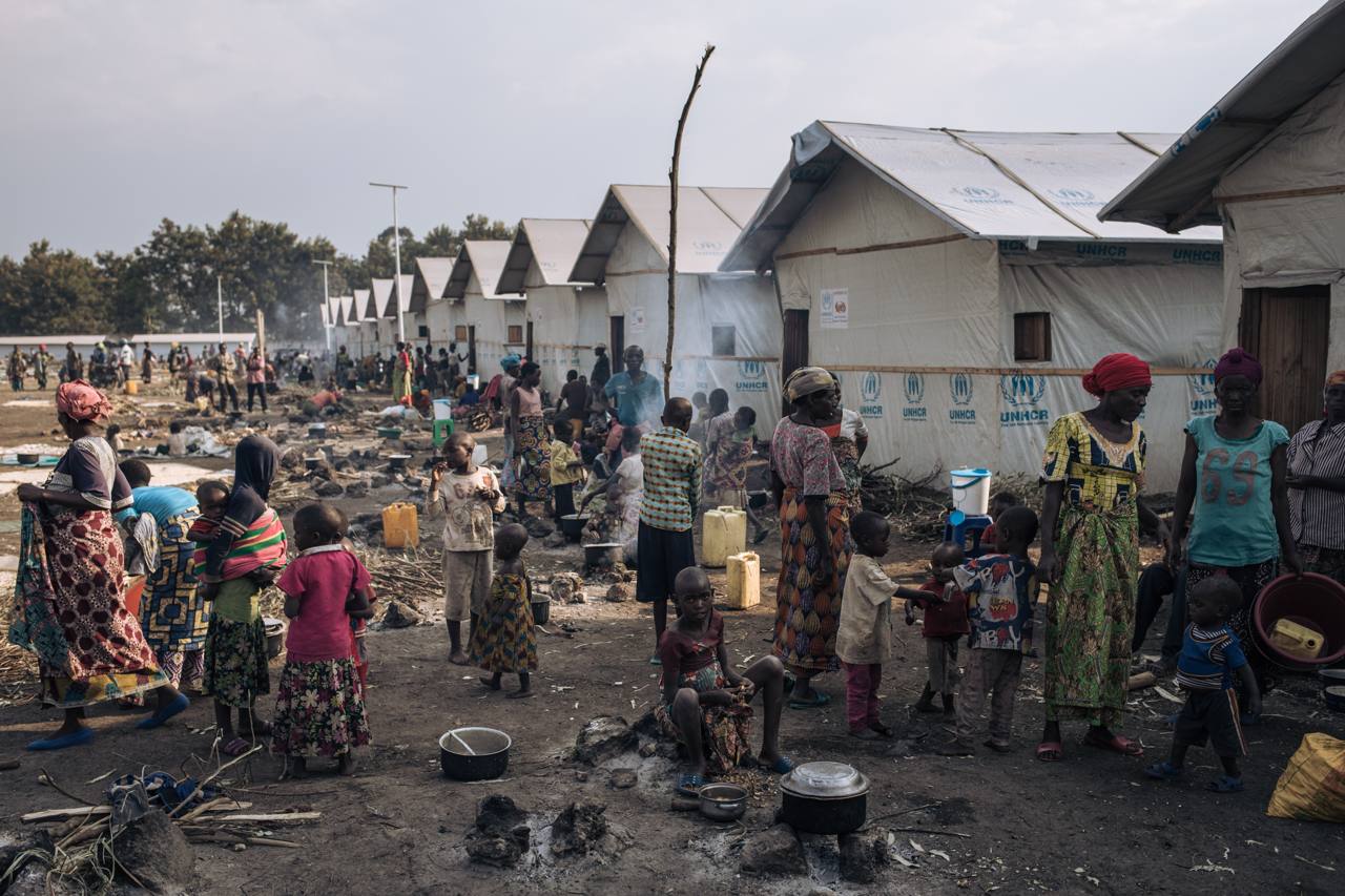 Displaced families prepare food in front of community shelters at an informal camp for displaced people in DR Congo (file photo)