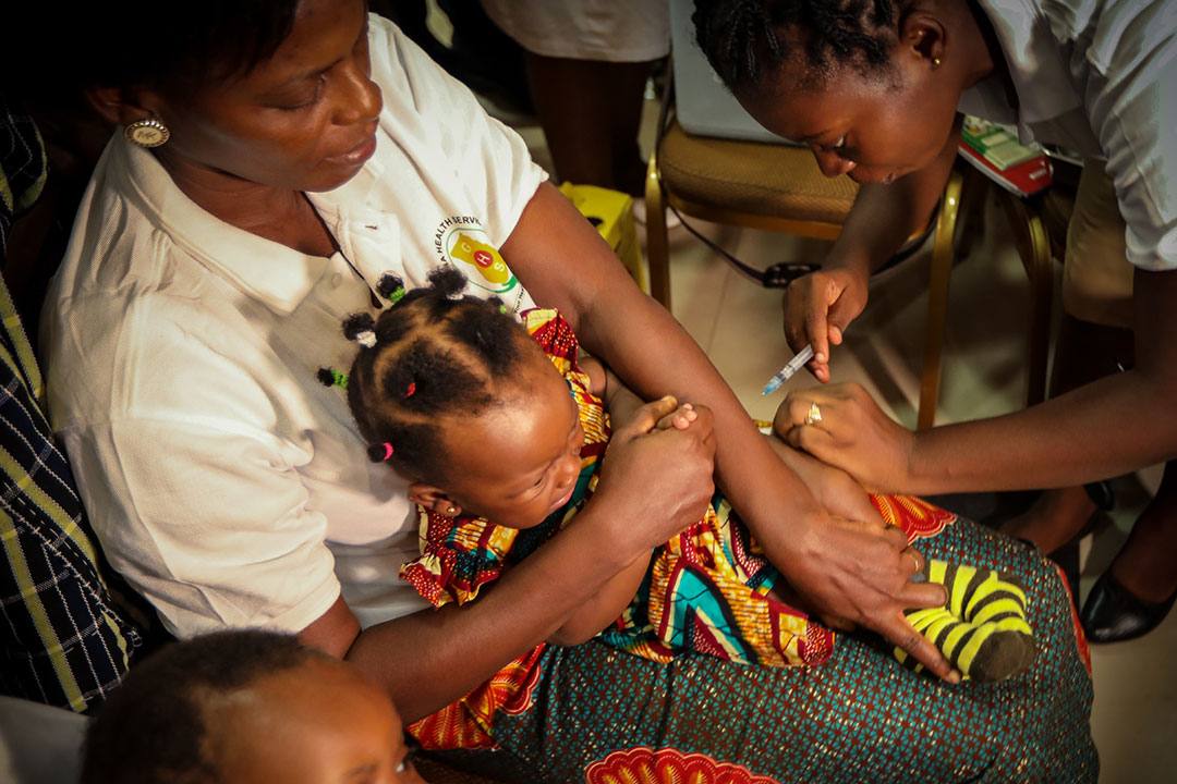 A health worker prepares a malaria vaccine dose during a vaccination launch in Ghana