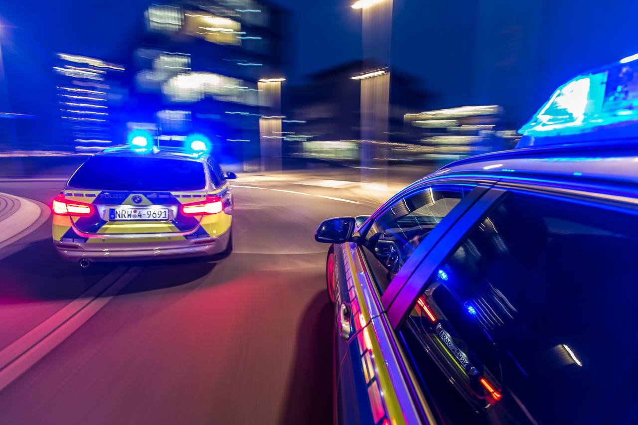 A German police patrol car at night with its blue light on (file photo)