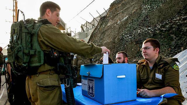 An Israeli soldier casting a ballot at a military polling station during a previous Knesset election (file photo)