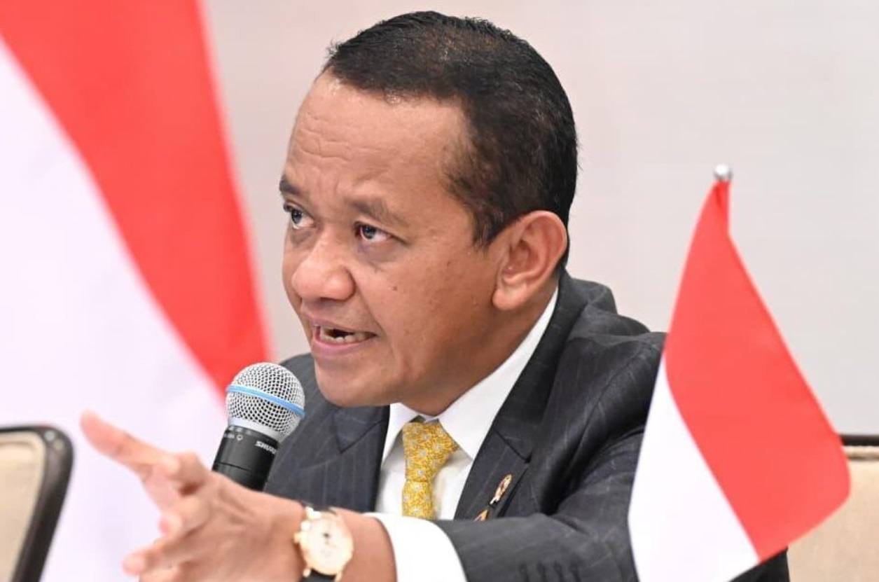 Indonesia's Energy and Mineral Resources Minister Bahlil Lahadalia speaking into a microphone with Indonesian flags behind him