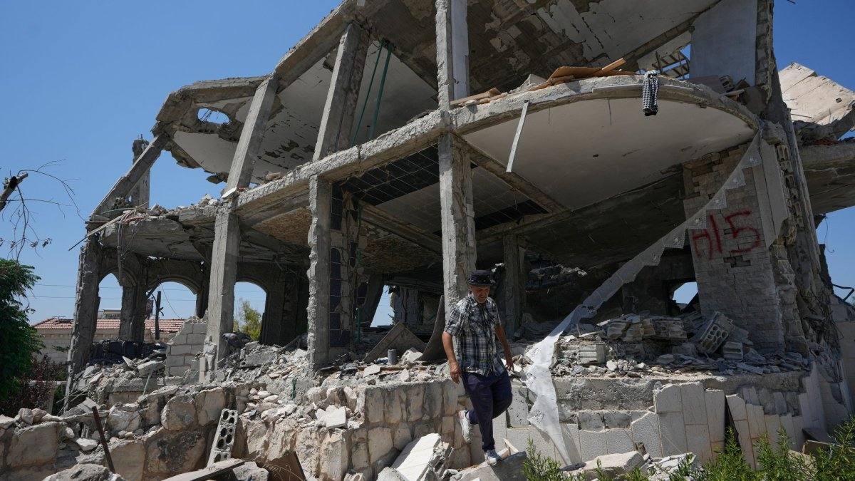 A man walks through the rubble of a destroyed building in southern Lebanon