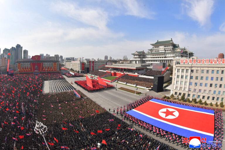 A North Korean military parade in Kim Il Sung Square, Pyongyang, with troops carrying a giant national flag (file photo)