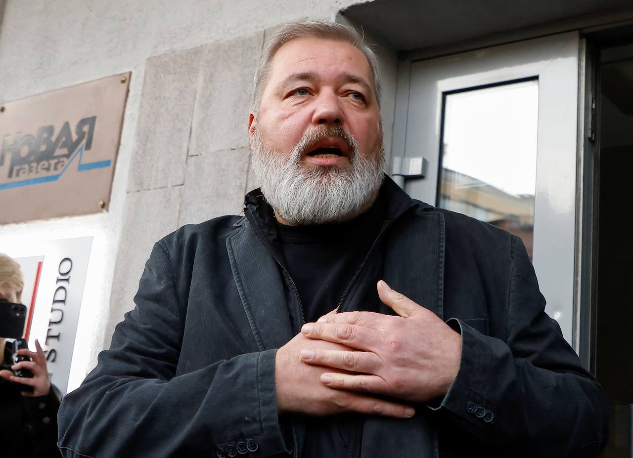 Novaya Gazeta publisher Dmitry Muratov speaking outside the newspaper's Moscow office, with the paper's sign behind him (file photo)