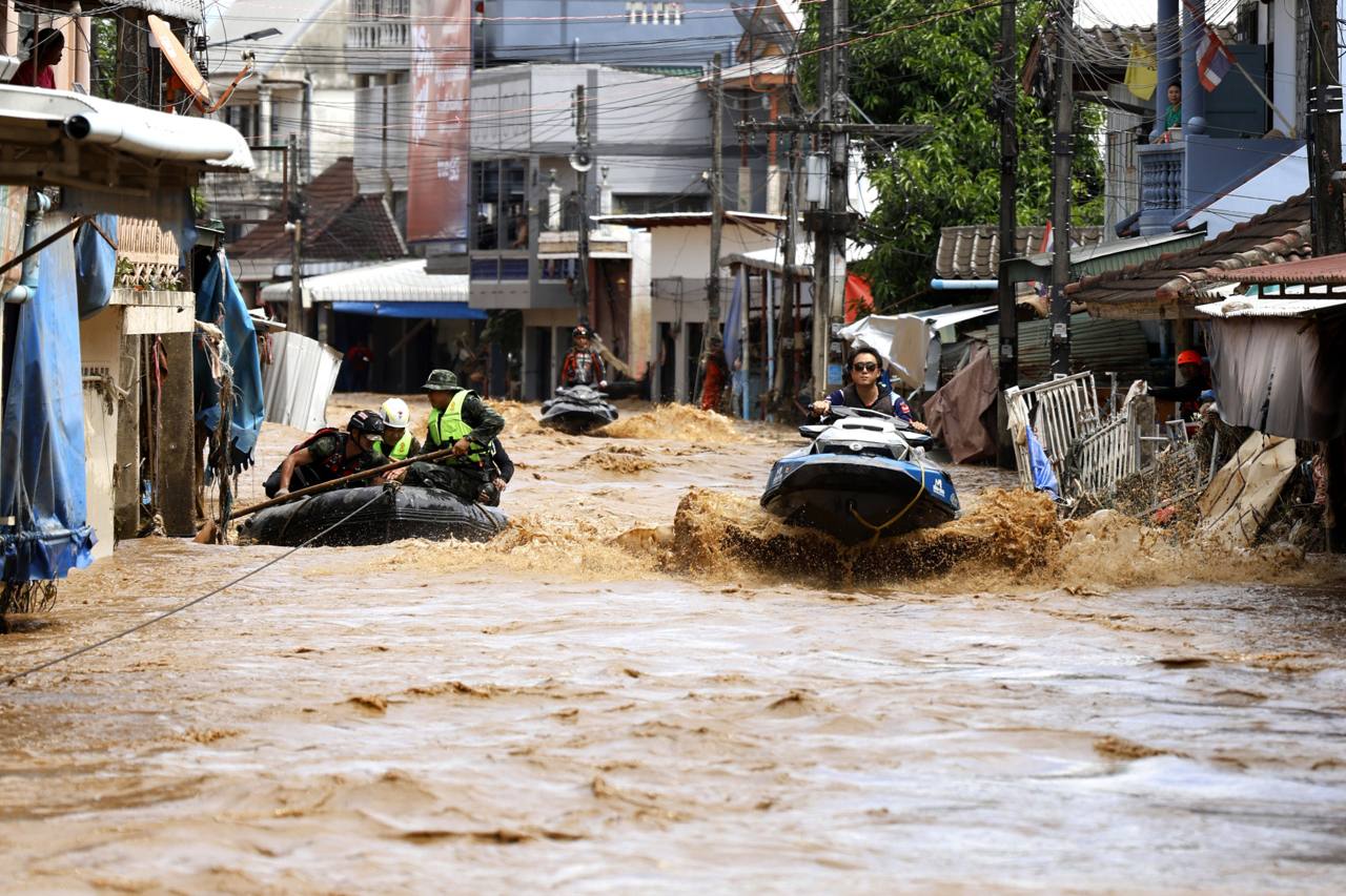 Rescue workers and a jet ski moving through a flooded street in Thailand (file photo)