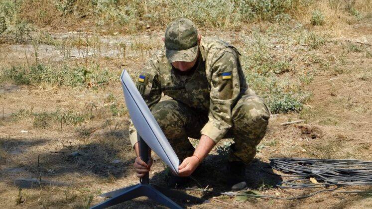 A Ukrainian soldier setting up a Starlink satellite terminal in the field (file photo)
