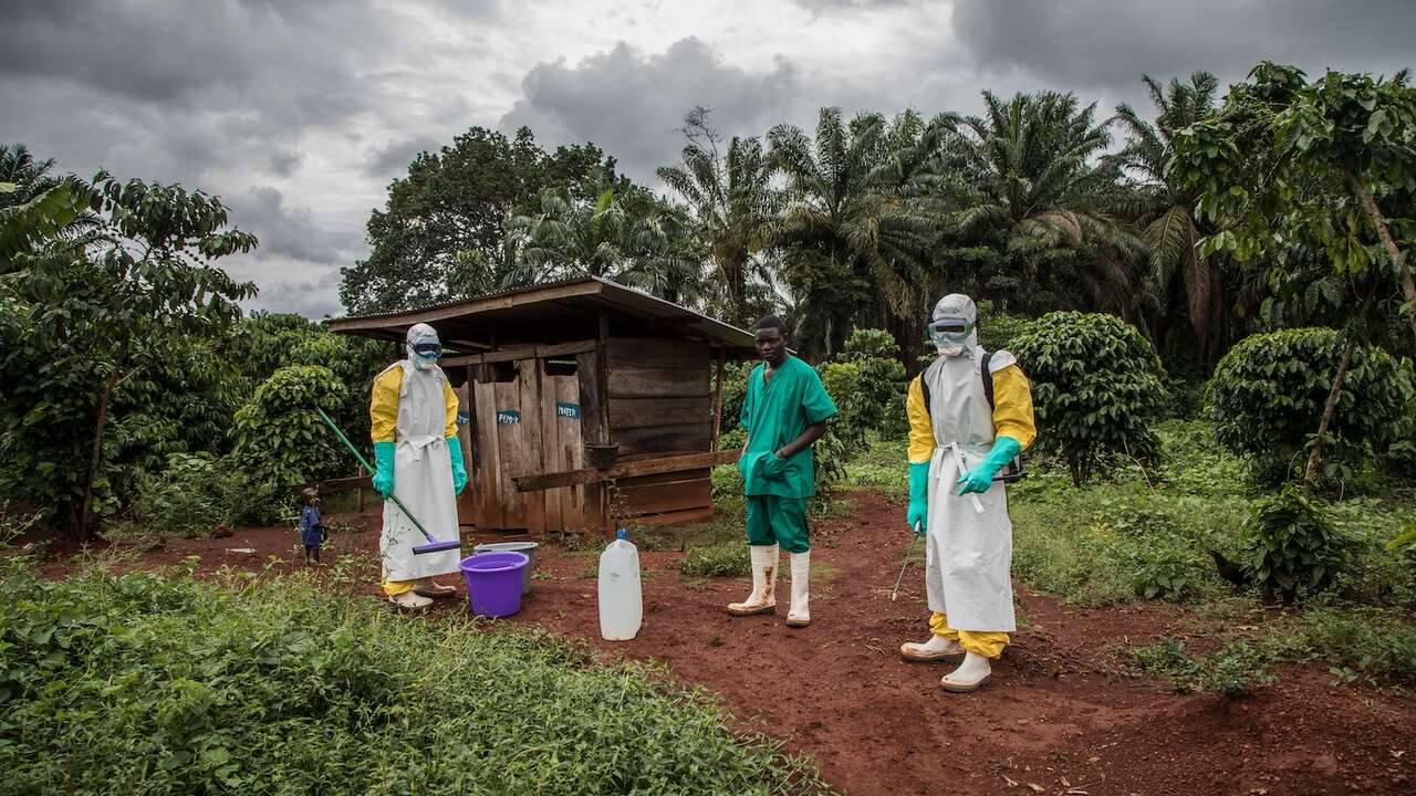 Health workers in protective gear disinfecting a health facility during an Ebola response in the Democratic Republic of Congo