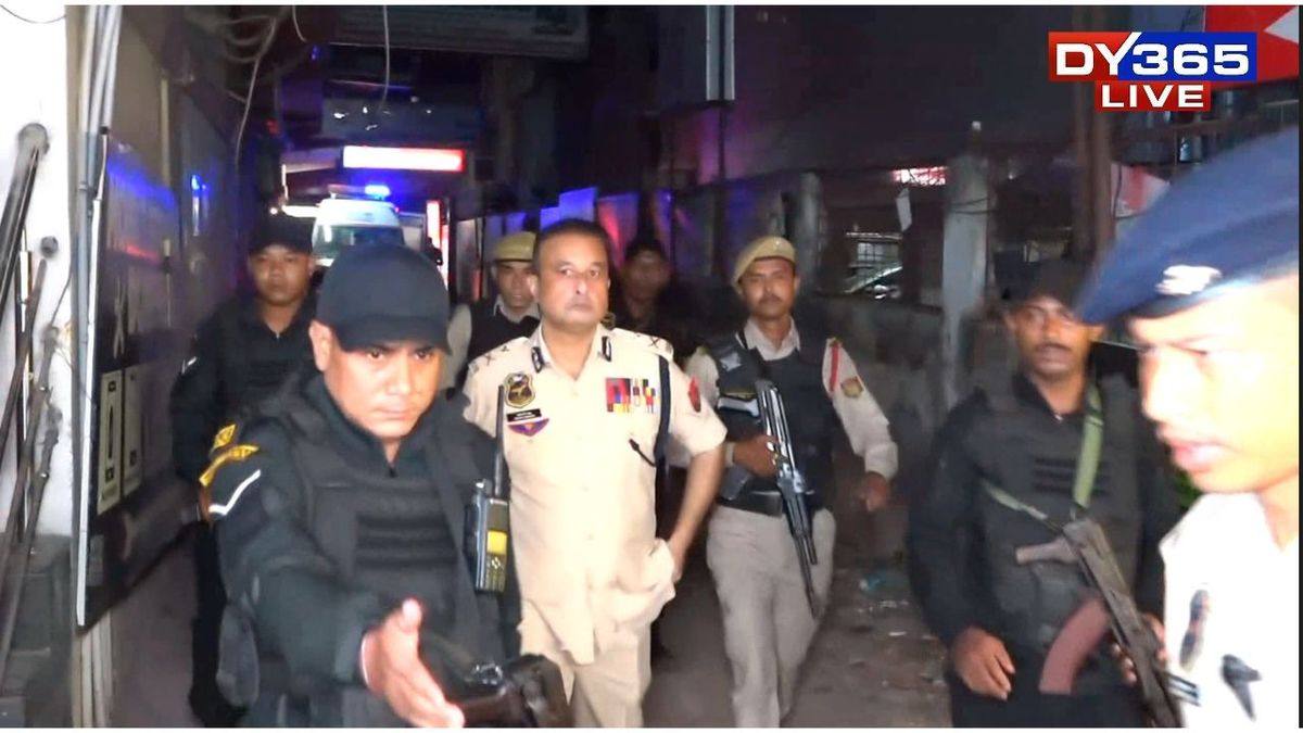 Police officers at night in the lane near Hotel Bilas Inn in Guwahati's Bora Service area after the shooting