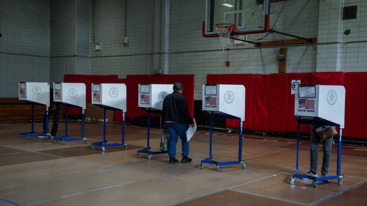 A voter carrying a ballot at a New York City polling place