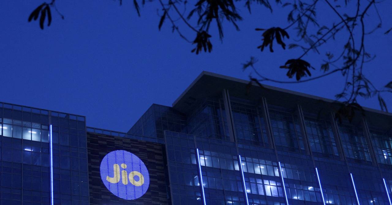 The Jio headquarters building at dusk with the illuminated Jio logo