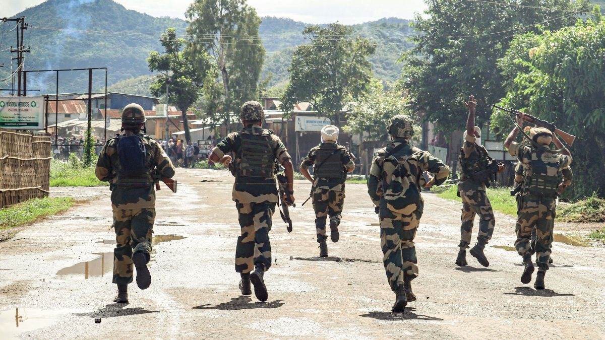 Security personnel running along a road in Manipur (file photo)