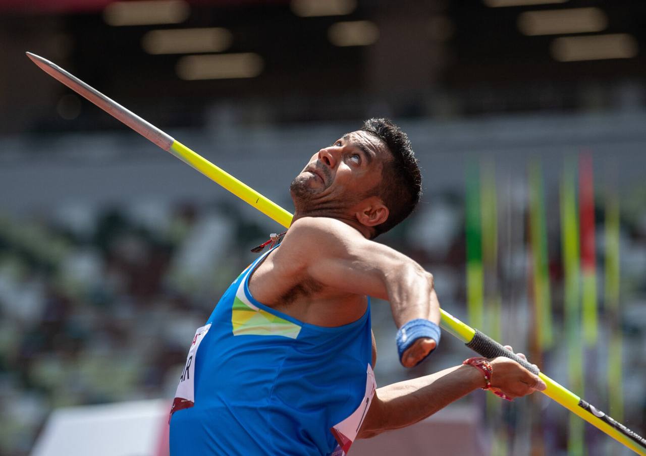 An Indian para-athlete in a blue India jersey throwing a javelin