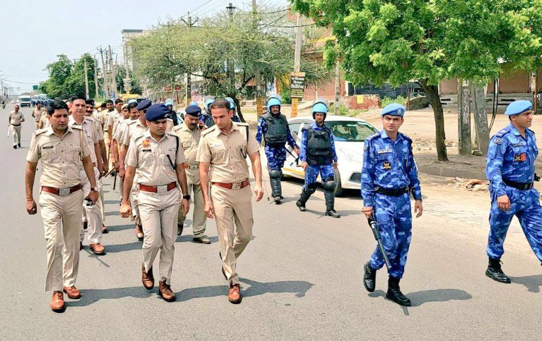 File photo: Haryana Police and Rapid Action Force personnel conducting a flag march on a street in Gurugram