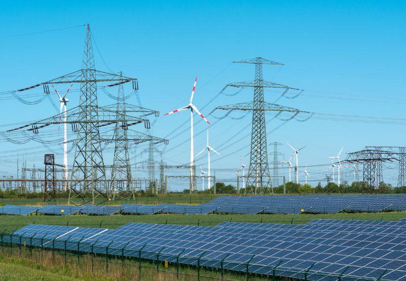 Electricity transmission towers with wind turbines and solar panels in Gujarat (file photo)