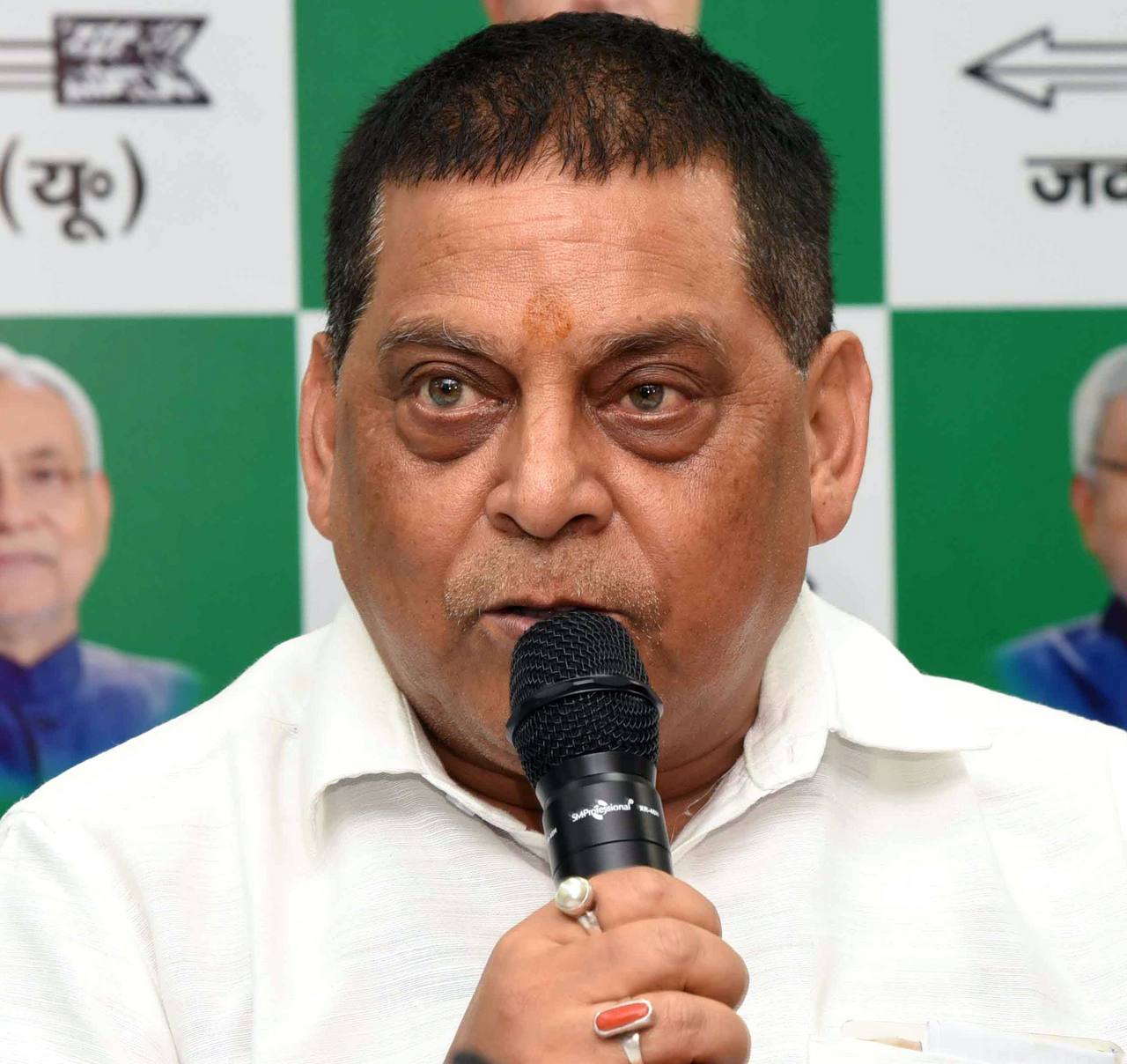 File photo: JD(U) leader and MLC Neeraj Kumar speaking into a microphone at a party event