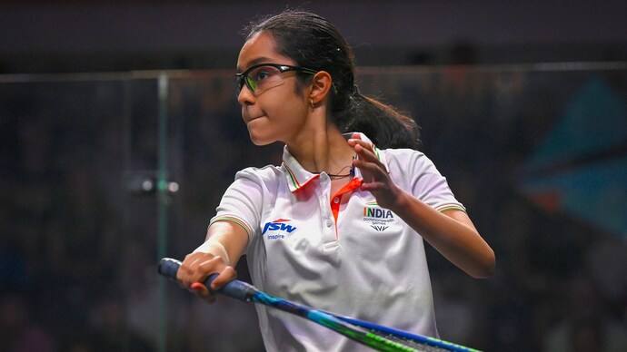 Anahat Singh in India colours playing a shot during a squash match