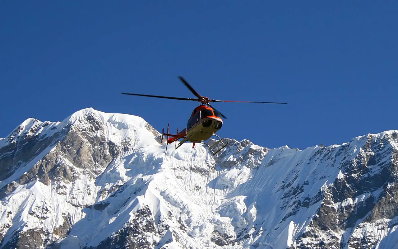 A helicopter flies over snow-covered Himalayan peaks in Uttarakhand (file photo)