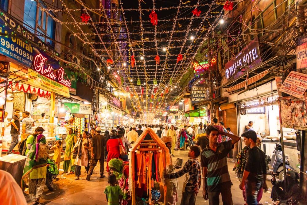Shoppers crowd a festively lit market street in Delhi's Chandni Chowk area at night (file photo)
