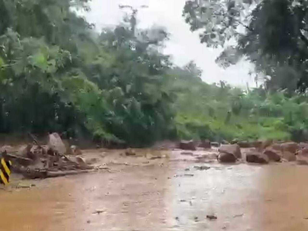 Floodwater and landslide debris covering a road in Odisha after heavy rainfall from Cyclone Arnab