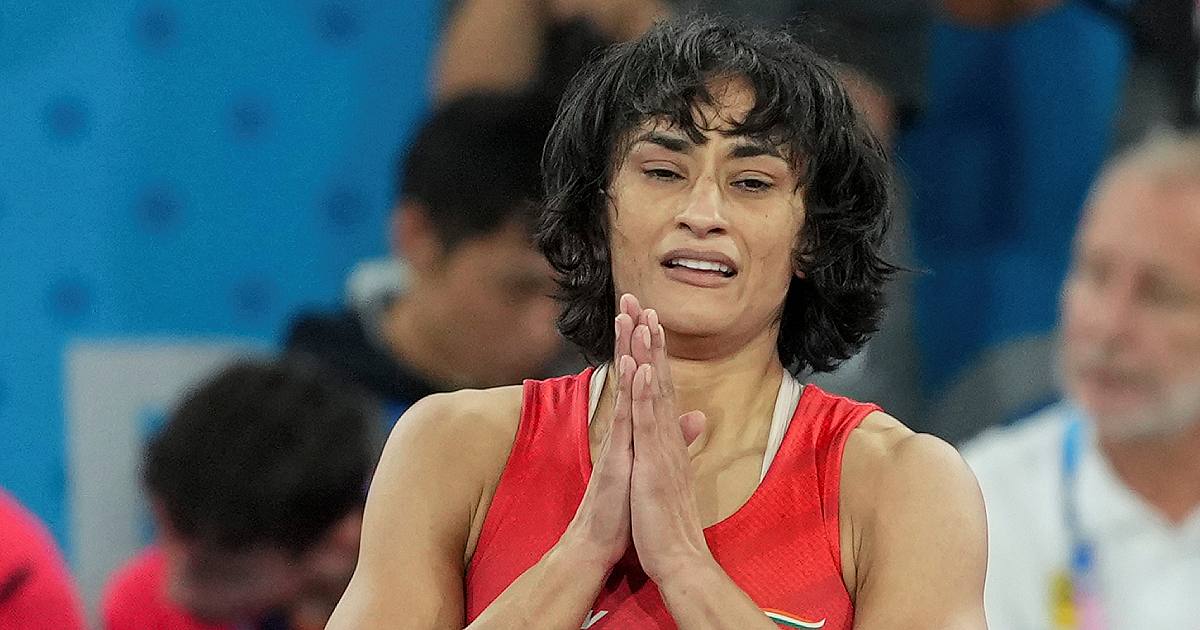 Wrestler Vinesh Phogat in a red India singlet with her hands folded during a competition (file photo)