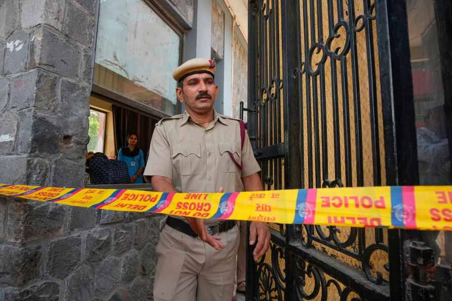 Delhi Police officer at a school gate behind a police cordon tape (file photo)