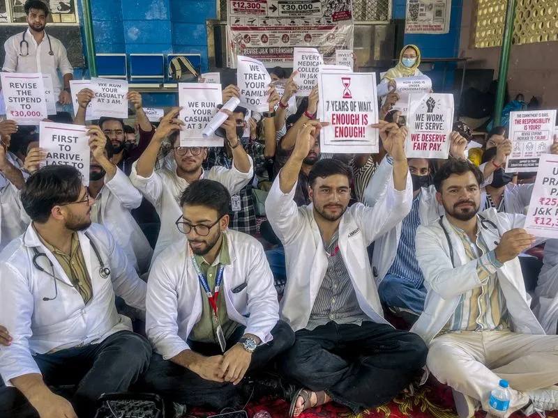 MBBS and BDS interns in white coats holding placards during their stipend protest in Jammu and Kashmir