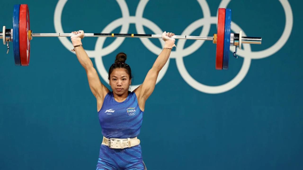 File photo of Indian weightlifter Mirabai Chanu lifting a barbell overhead in India colours at the Olympic Games