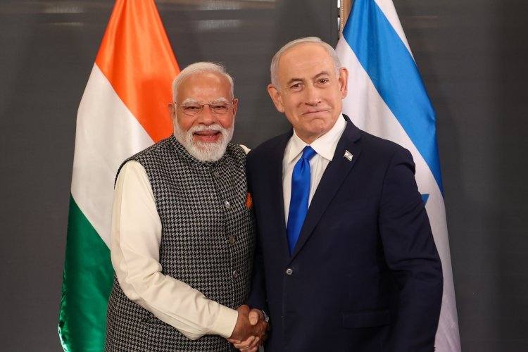 Prime Minister Narendra Modi shaking hands with Israeli Prime Minister Benjamin Netanyahu in front of the Indian and Israeli flags