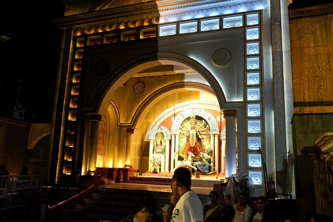File photo of a Durga Puja pandal in Kolkata at night, with visitors in front of the illuminated idol