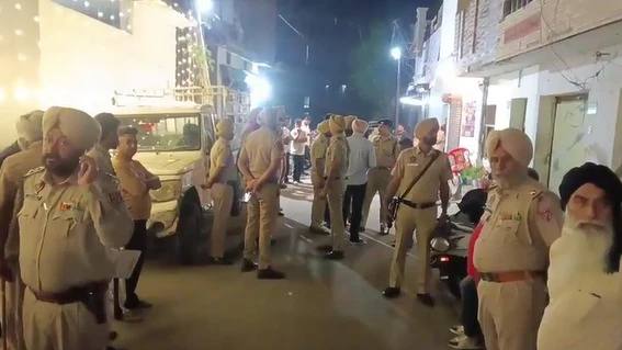 Punjab Police officers at the scene in Moga's Angadpura neighbourhood on Sunday night after gunmen opened fire on people sitting outside a shop