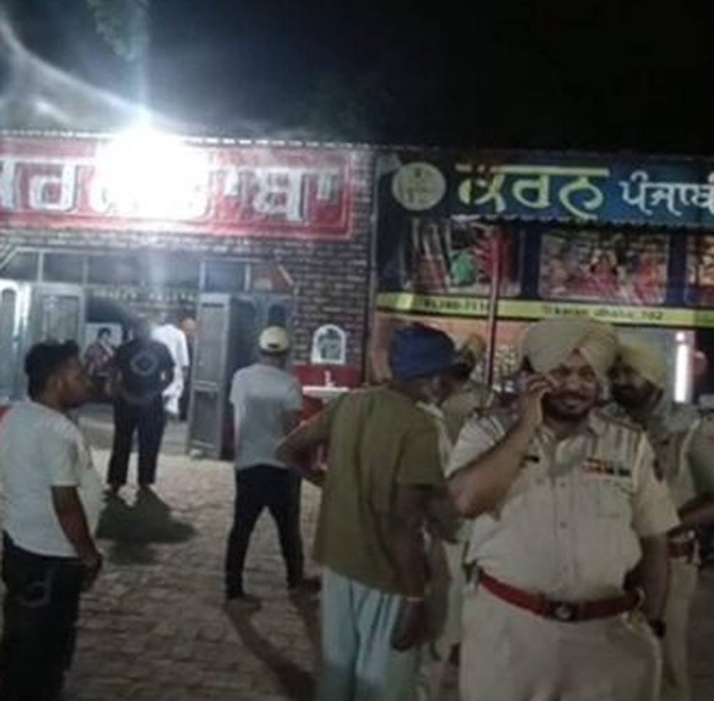 Police outside Karan Dhaba in Jalalabad Purbi, Moga district, at night after the shooting