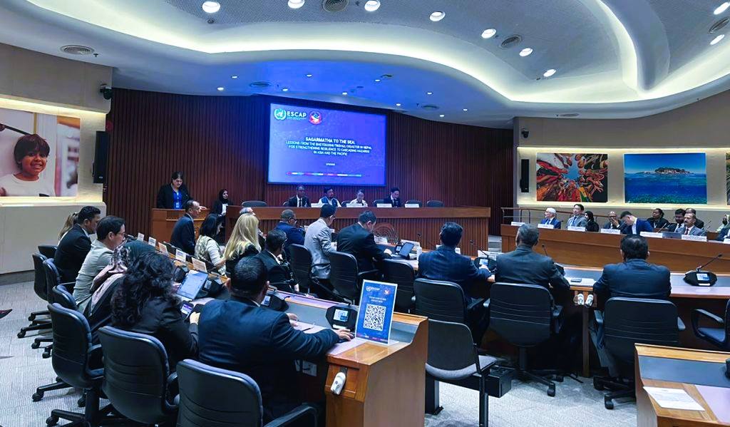 Delegates seated in a conference hall in Bangkok beneath an ESCAP screen reading Sagarmatha to the Sea during Nepal's regional climate dialogue