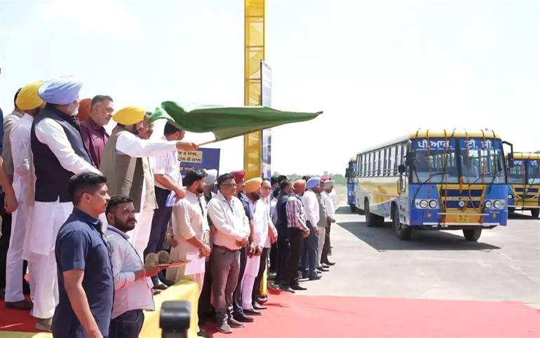 Chief Minister Bhagwant Mann waving a green flag as a new PRTC bus approaches during the flag-off ceremony in Patiala, with officials standing alongside