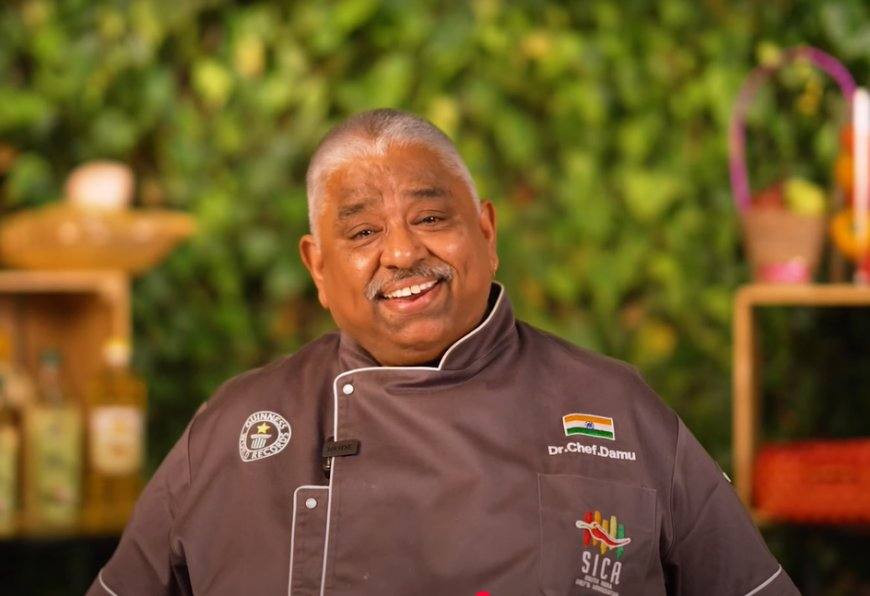 Chef Damu in his chef's coat smiling at the camera (file photo)