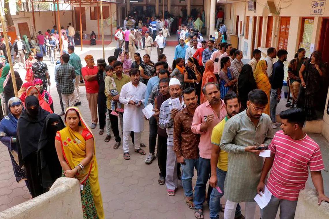 Voters queue at a polling station in India (file photo)