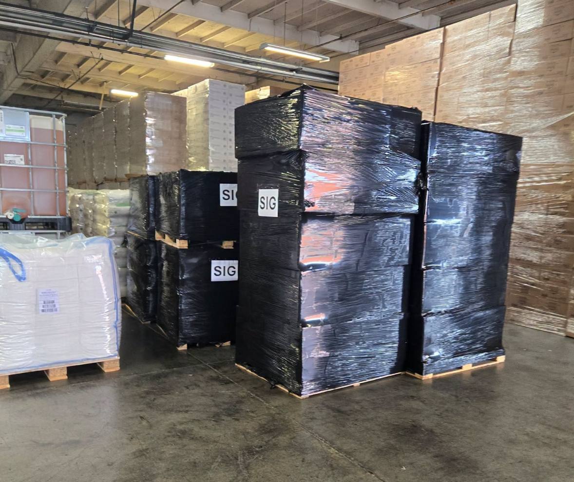 Recovered black-wrapped pallets labelled SIG inside a warehouse in the Los Angeles County Sheriff's Department cargo recovery in Torrance, California