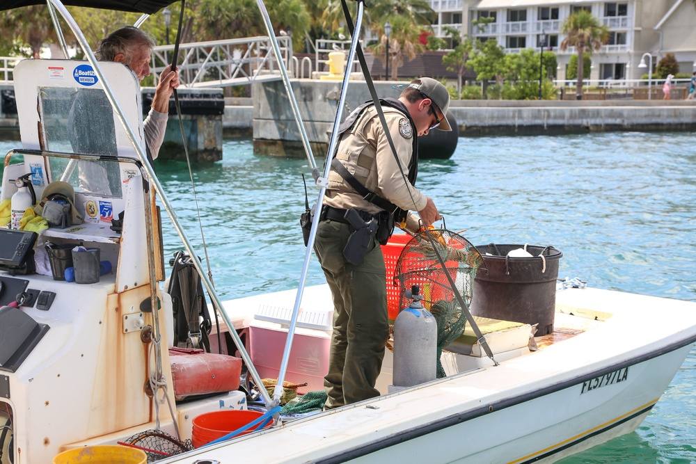 File photo of U.S. Coast Guard and Florida Fish and Wildlife Conservation Commission officers conducting a fisheries boarding on a boat off Florida
