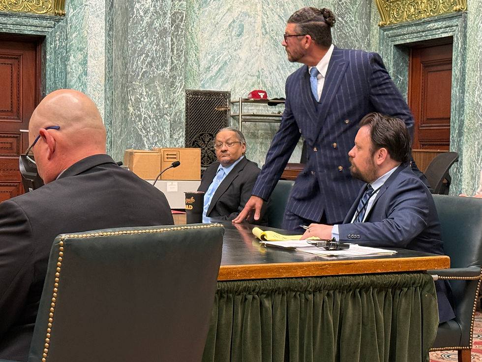 Raphael Helton seated in an Allen Superior Court courtroom in Fort Wayne during his murder trial, with his defence attorneys beside him