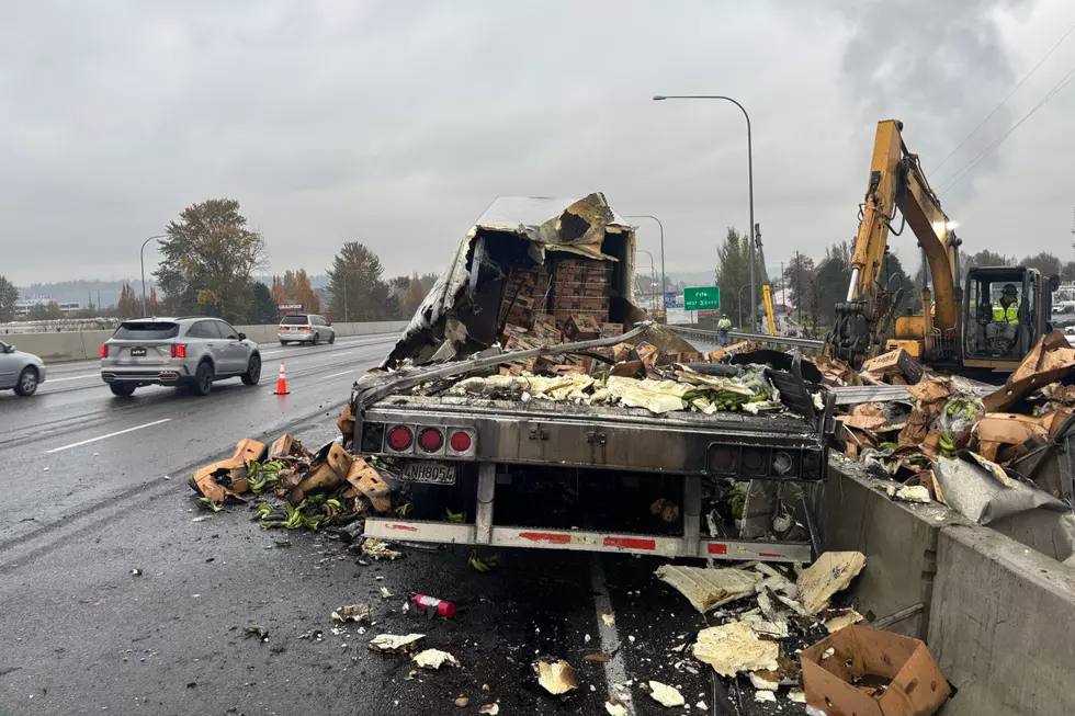 Burned-out semi trailer that had been carrying bananas on Interstate 5 in Tacoma, Washington, with produce boxes and debris scattered across the lanes during cleanup