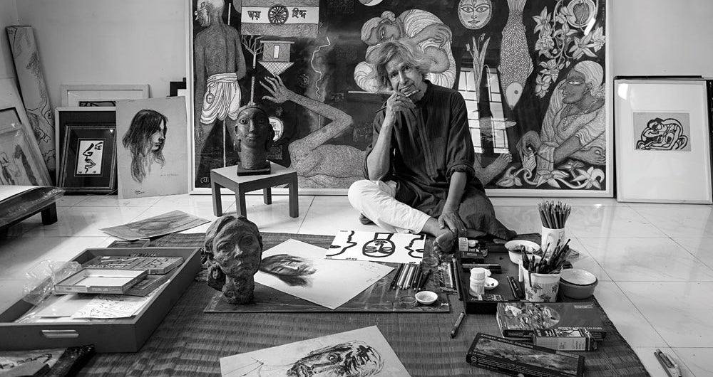 Painter Jogen Chowdhury seated in his studio surrounded by his artworks (file photo)